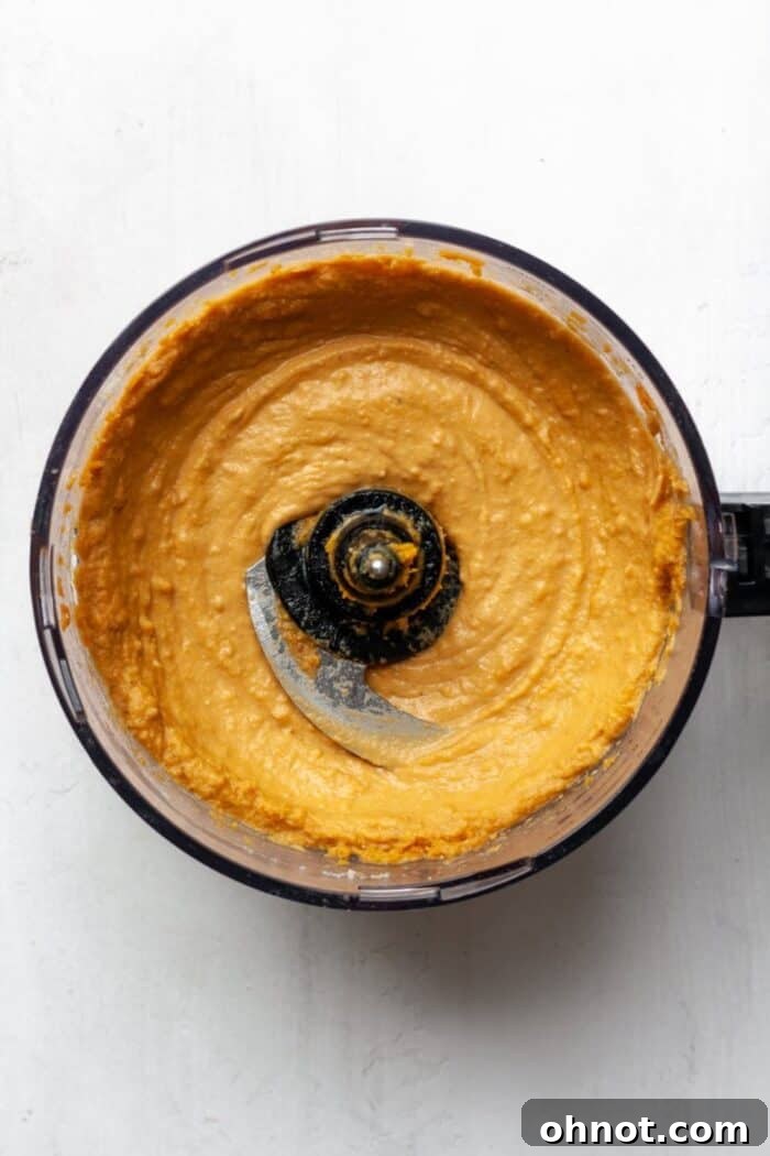 A creamy, smooth sweet potato puree swirling in a blender, perfectly mixed and ready for baking.