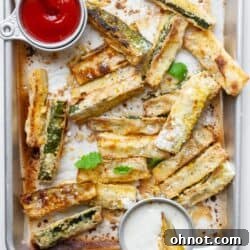 Vegan zucchini fries on baking pan with ketchup