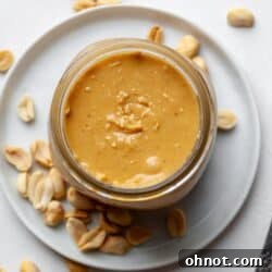 Vitamix peanut butter in a glass jar, perfectly smooth and creamy.