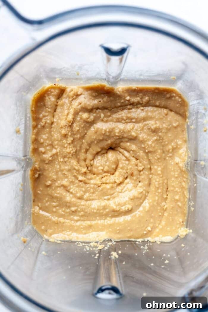 Smooth, creamy homemade peanut butter swirling in a blender after 1 minute 30 seconds of blending.