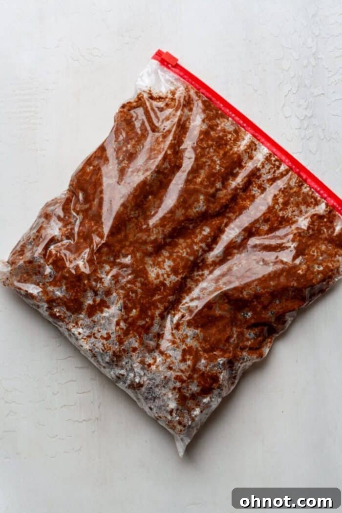 Muddy buddies coated with powdered sugar inside a Ziplock bag after shaking.