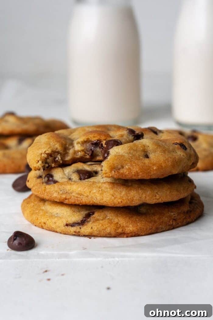 Warm dairy-free chocolate chip cookies served with a glass of almond milk.