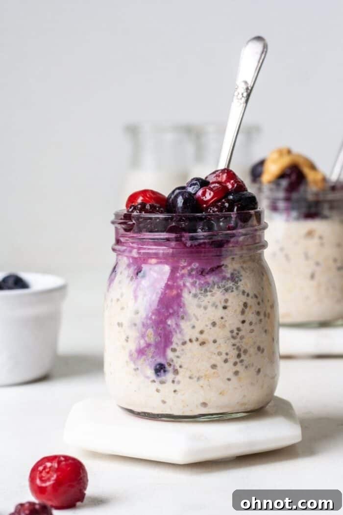 Overnight oats with frozen fruit in a glass jar, ready to eat