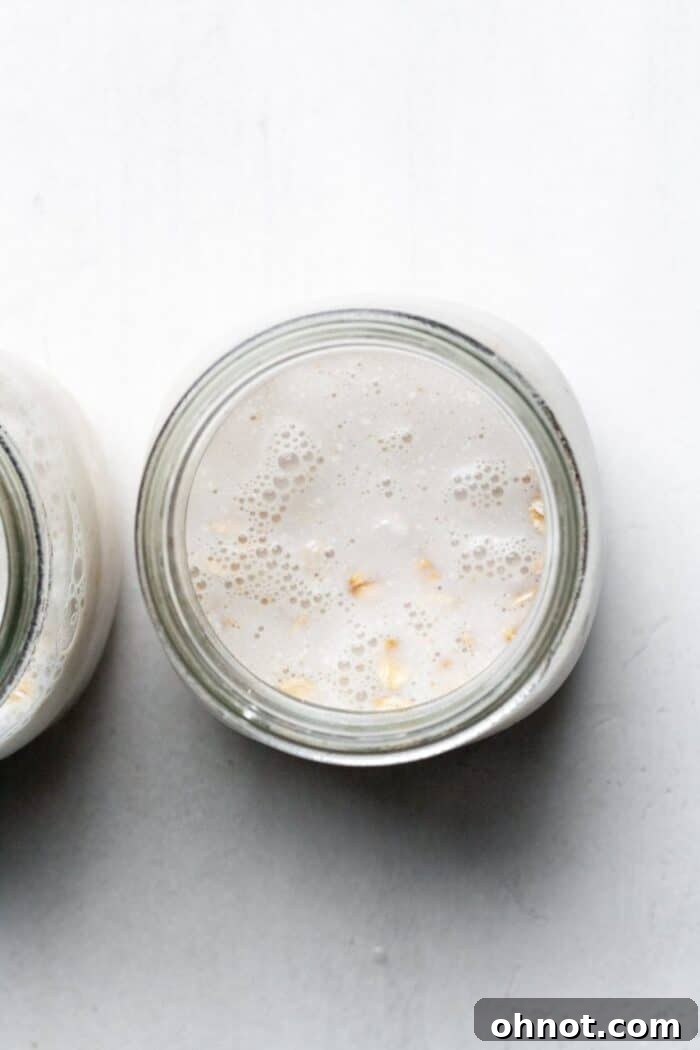 Oats and almond milk layered in a glass jar