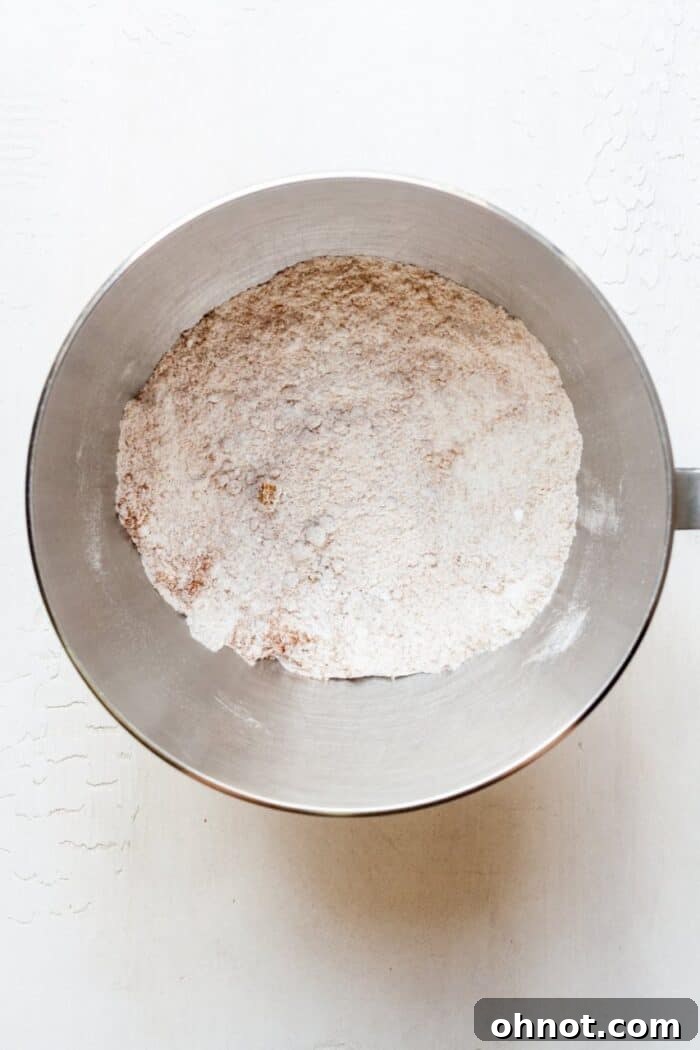 Dry ingredients for pumpkin cookies in a mixing bowl, ready to be combined.