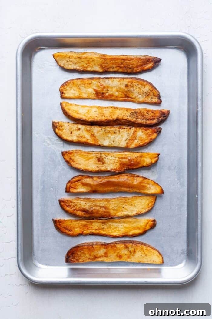 Baked fries on a pan, golden and ready to serve