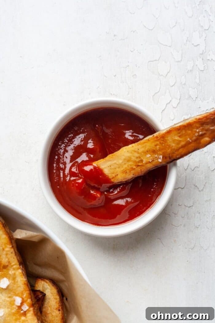 Whole30 French fry dipped in ketchup