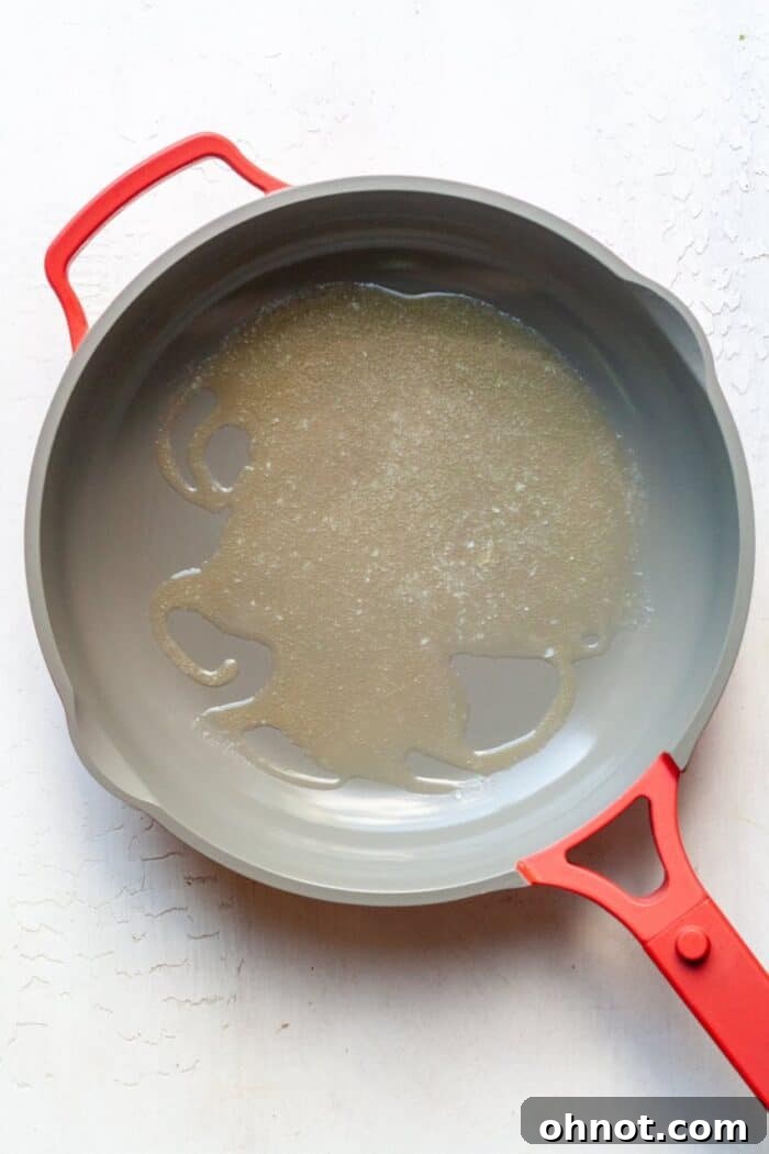 Butter melting in a hot skillet, ready for searing fish.