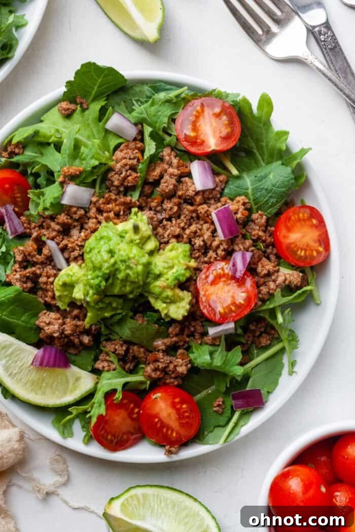 A vibrant Paleo salad featuring perfectly seasoned meat and an abundant array of fresh vegetables and creamy avocado.