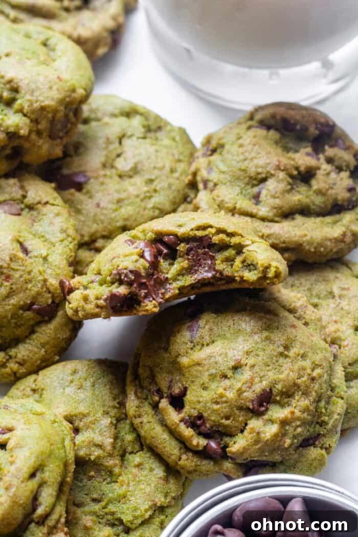 Stacked gluten-free matcha chocolate chip cookies on a plate