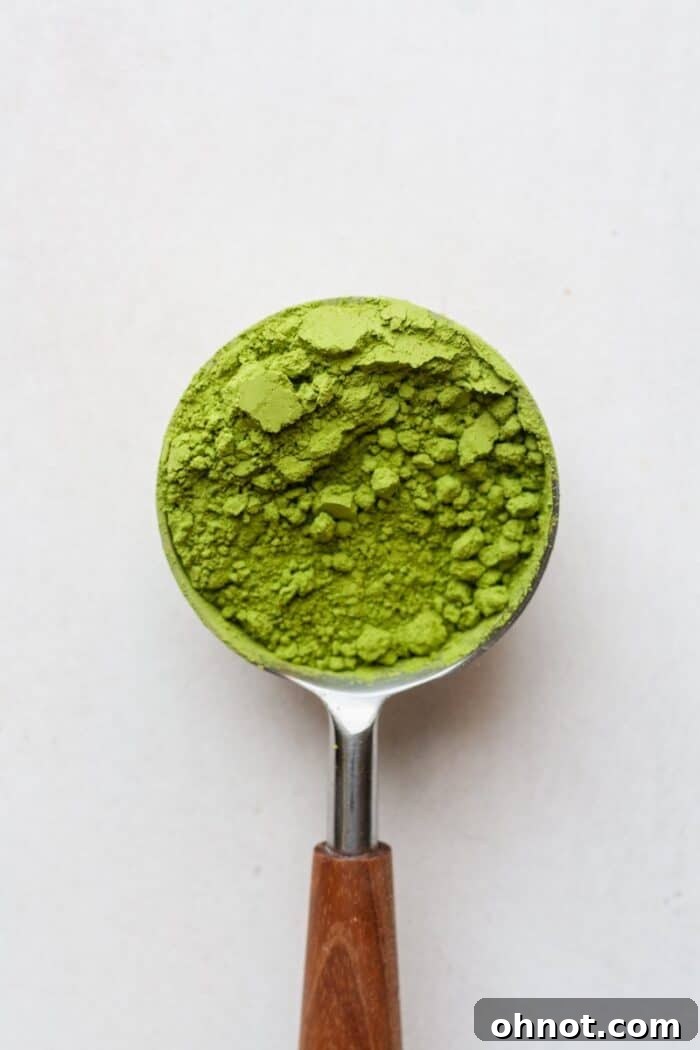 Close-up of vibrant green matcha powder in a small bowl