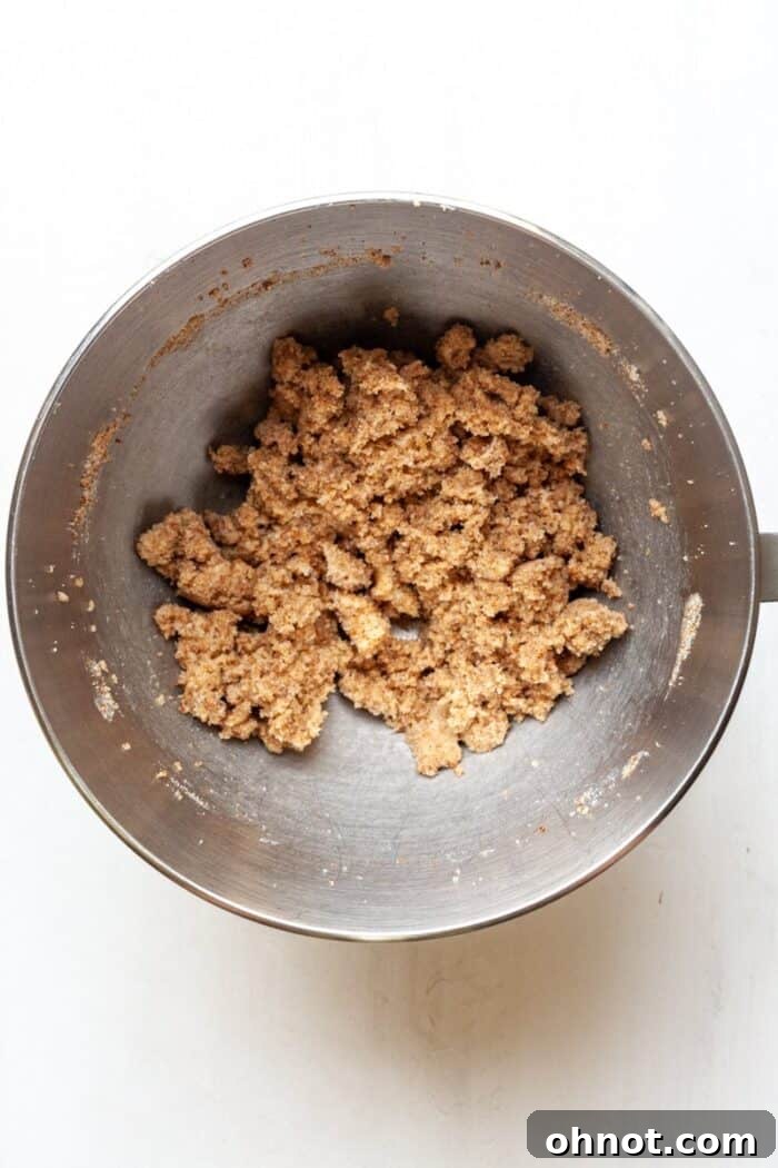 Butter and sugars being creamed together in a mixing bowl