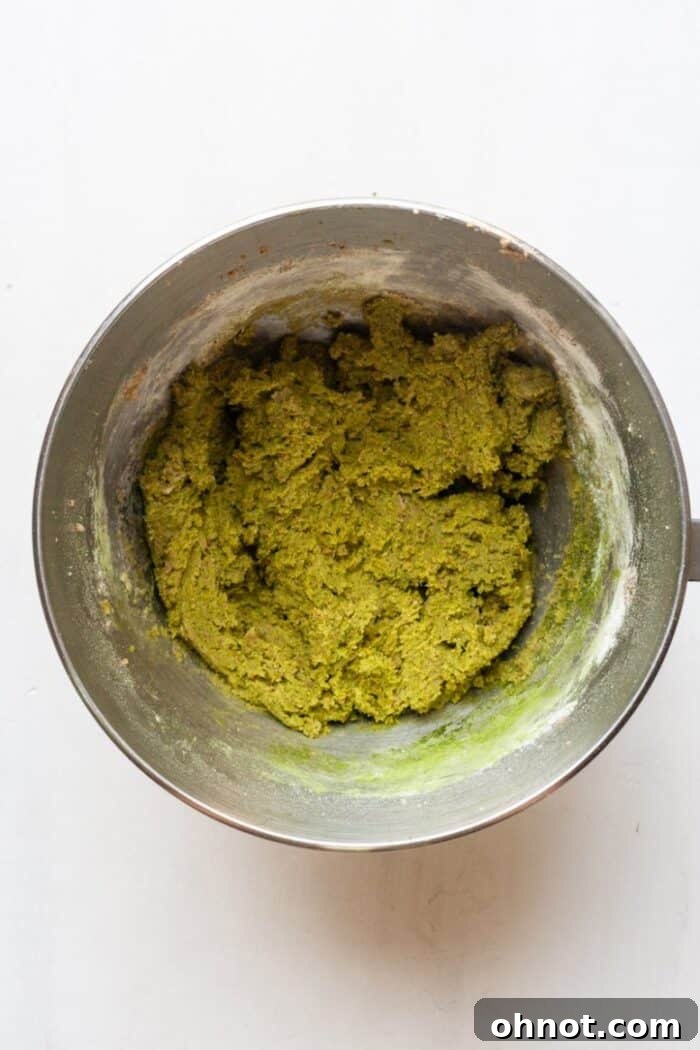 Vibrant green matcha flavored cookie dough in a mixing bowl