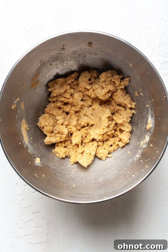 Creamed butter and sugar in a bowl, forming the base for cookie dough