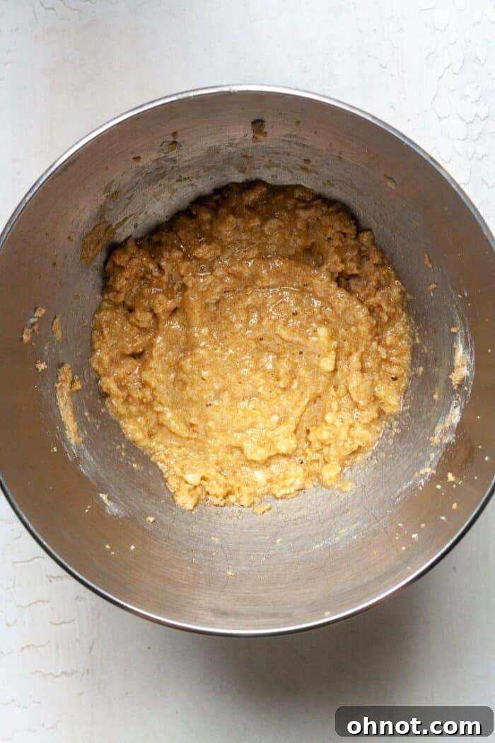 Wet ingredients (egg, butter, sugar) blended in a mixing bowl