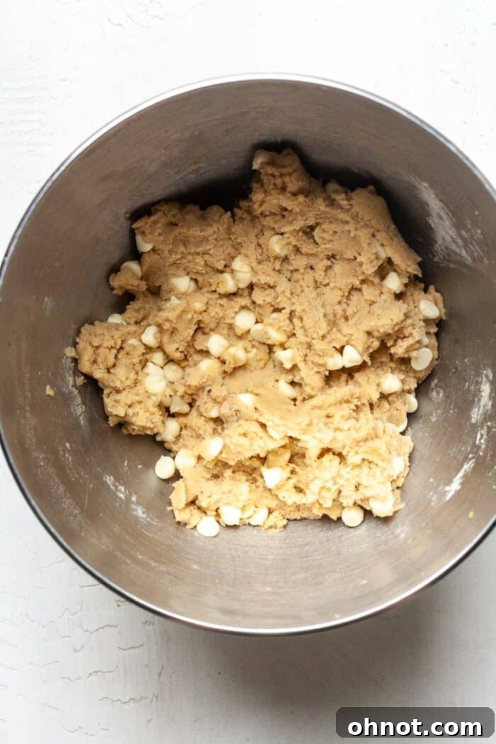 Cookie dough with white chocolate chips evenly distributed