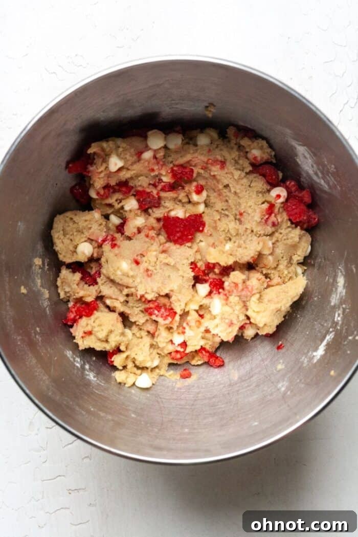 Raspberry cookie dough in a bowl, ready for refrigeration