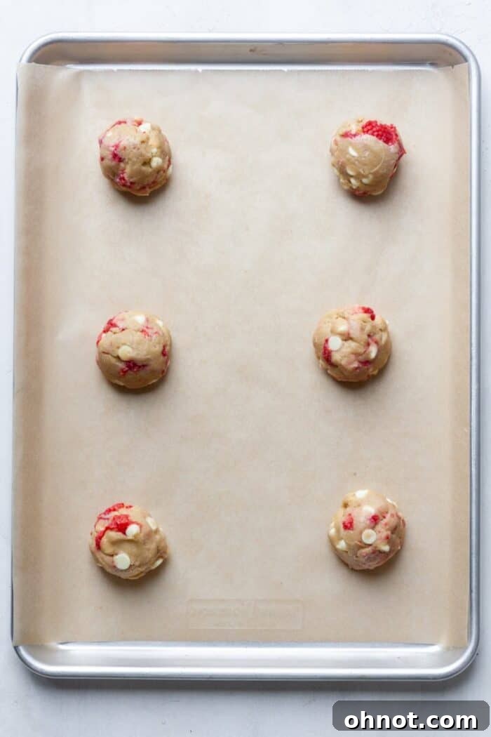 Uniform cookie dough balls placed on a baking pan