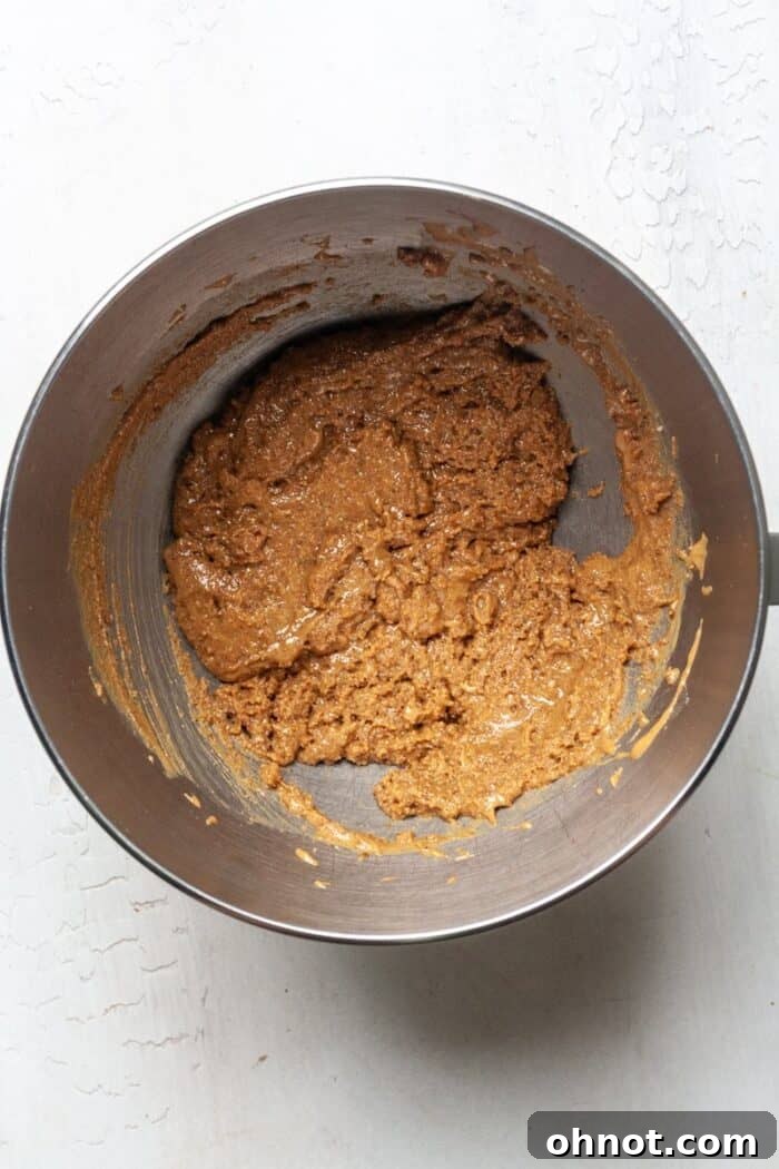 Creamy peanut butter and Keto brown sugar being mixed in a bowl.