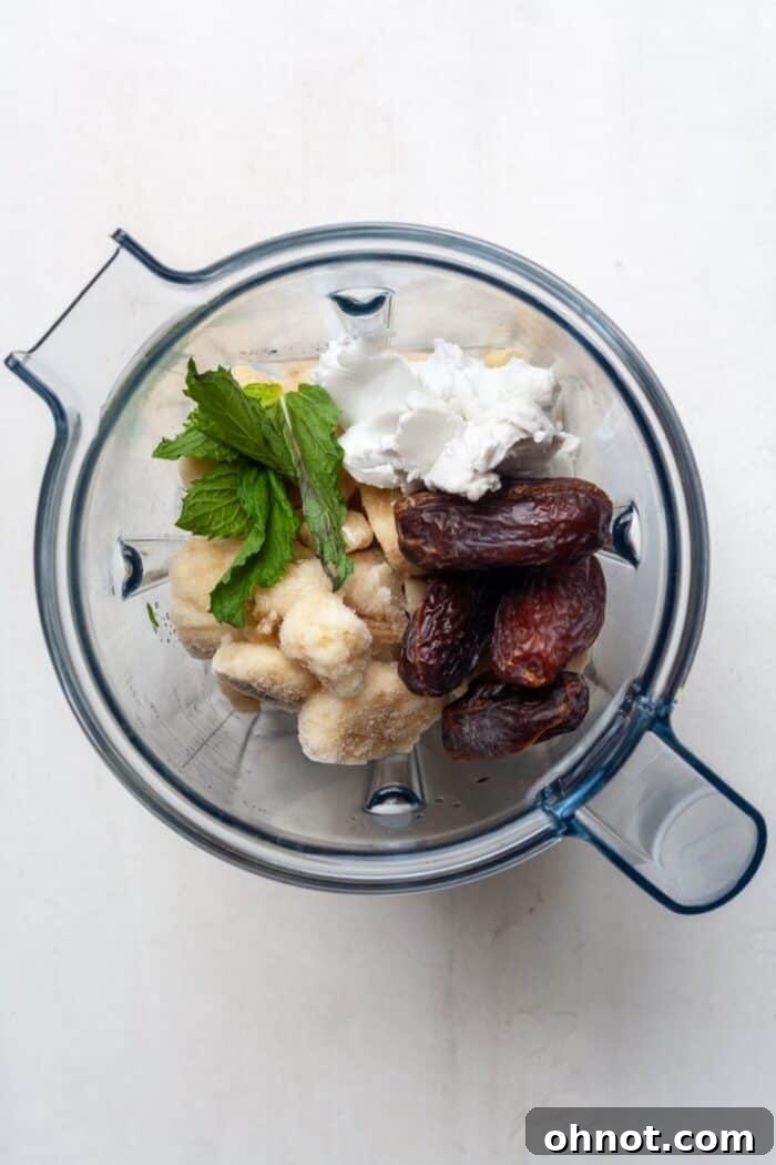 Mint and bananas being added to a blender