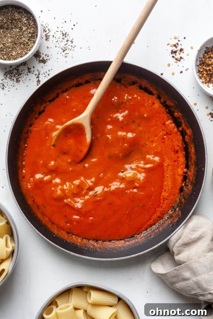 Coconut milk pasta sauce in skillet, vibrant and creamy