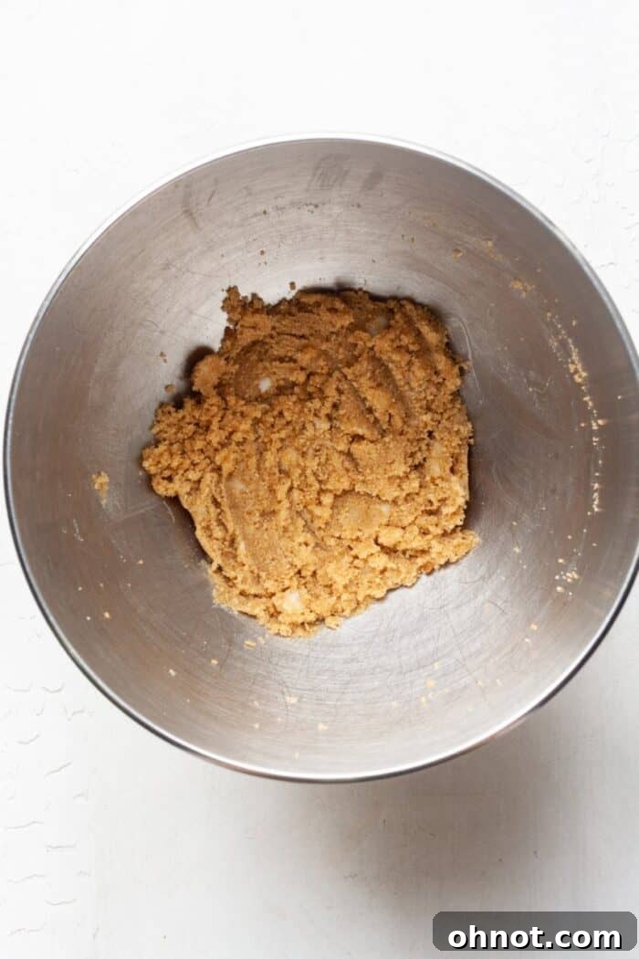Creamed room temperature coconut oil and light brown sugar in a mixing bowl, ready for the next ingredients.
