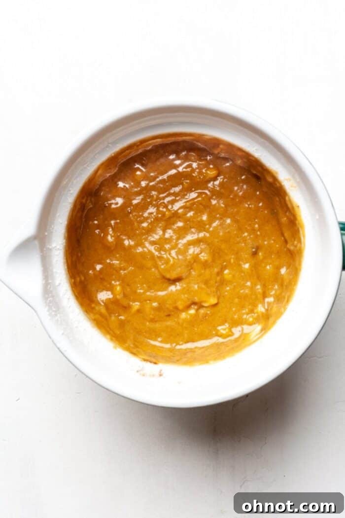Banana muffin batter in a bowl after dry ingredients are mixed in.