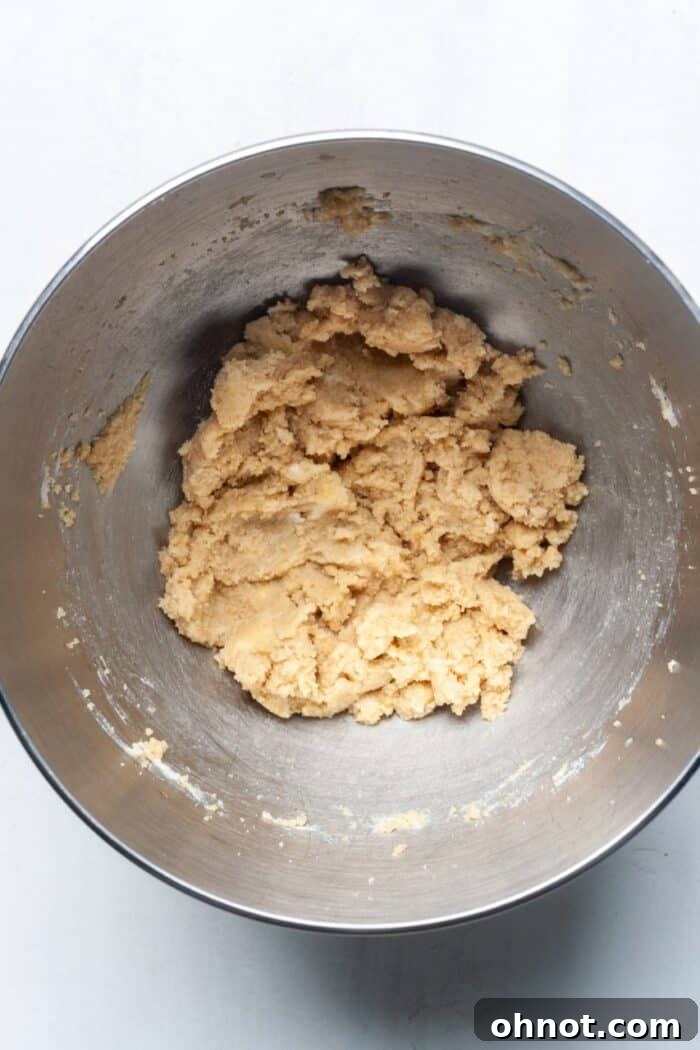 Butter and sugar being creamed together in a mixing bowl