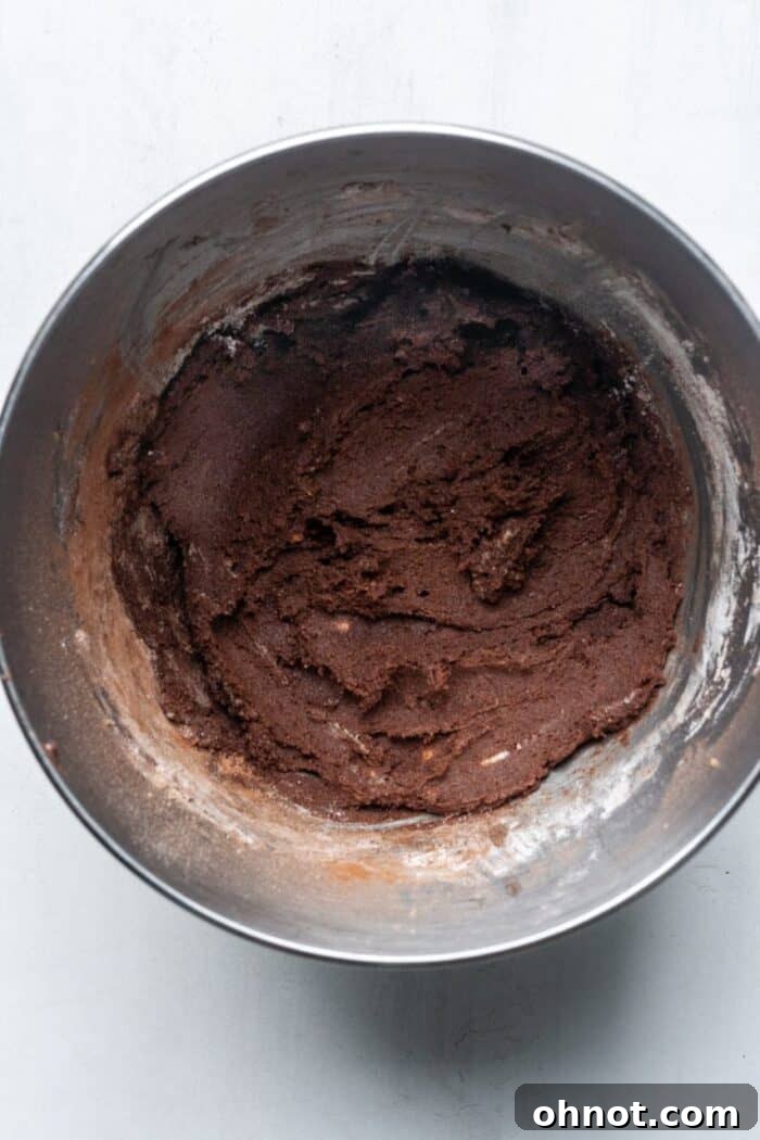 Thick chocolate cookie dough in a mixing bowl