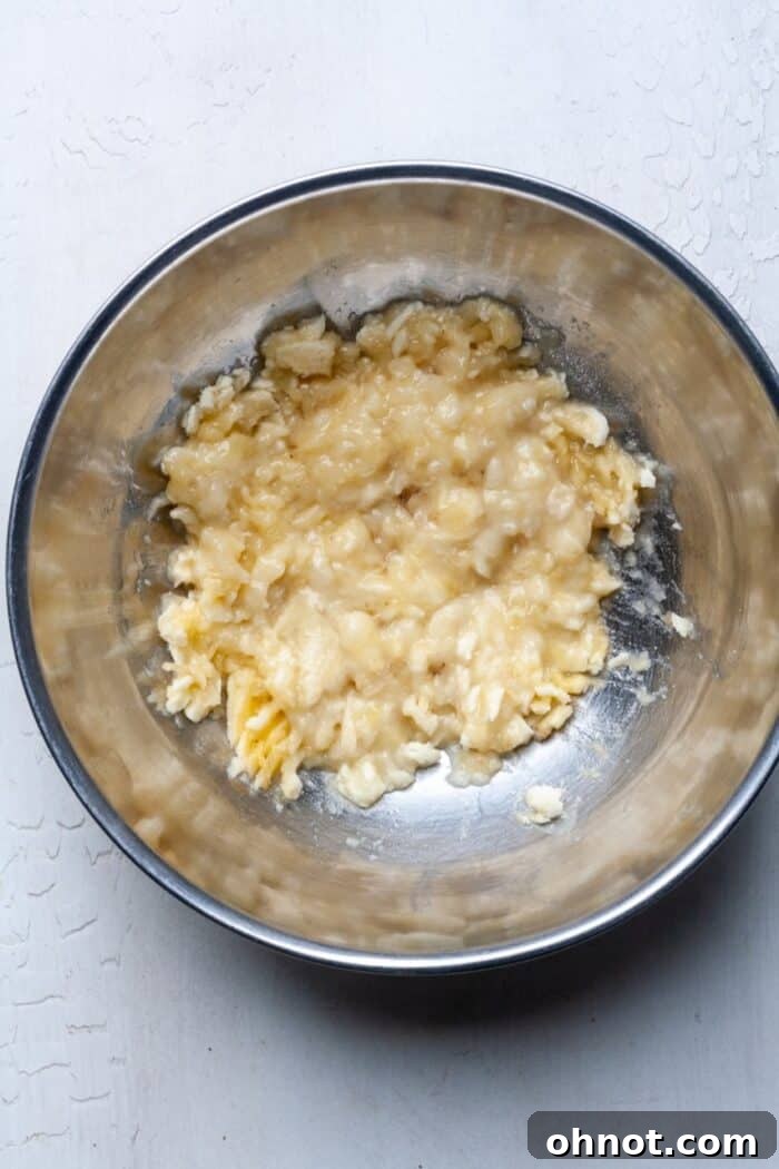 Well-mashed bananas in a mixing bowl