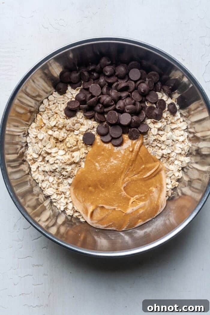Peanut butter, oatmeal, and chocolate chips added to mashed bananas