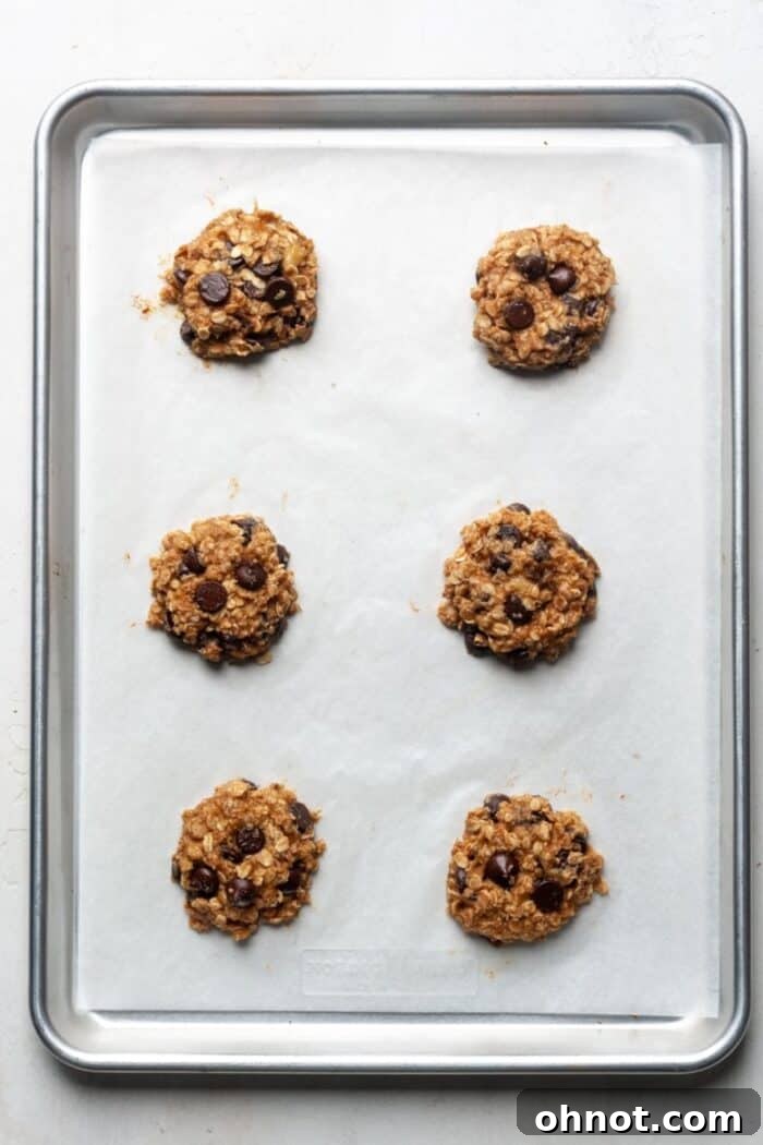 Baked peanut butter banana oat cookies on a sheet