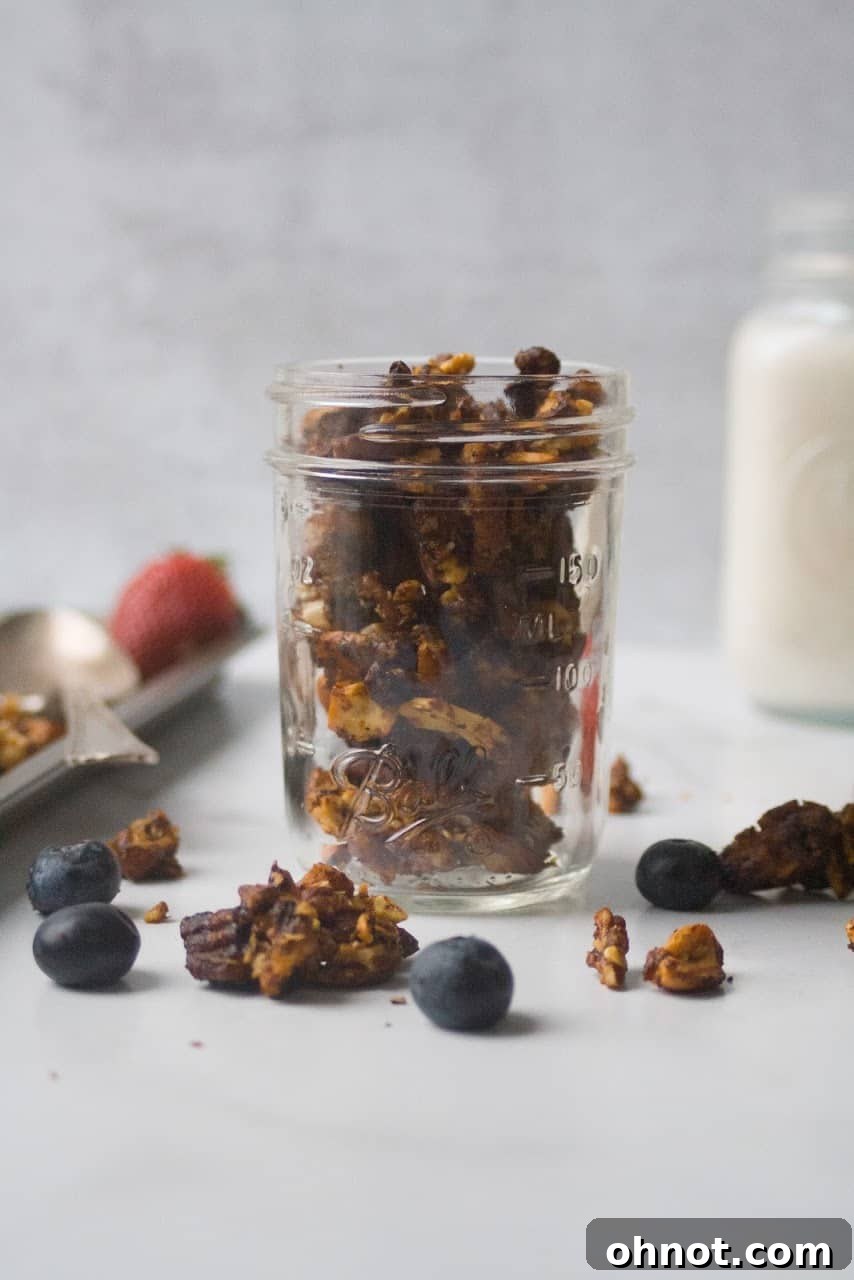 Granola cooling on a baking sheet lined with parchment paper