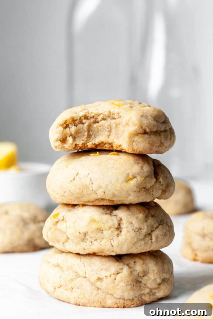 Stack of freshly baked Vegan lemon cookies, showing their soft and chewy texture.