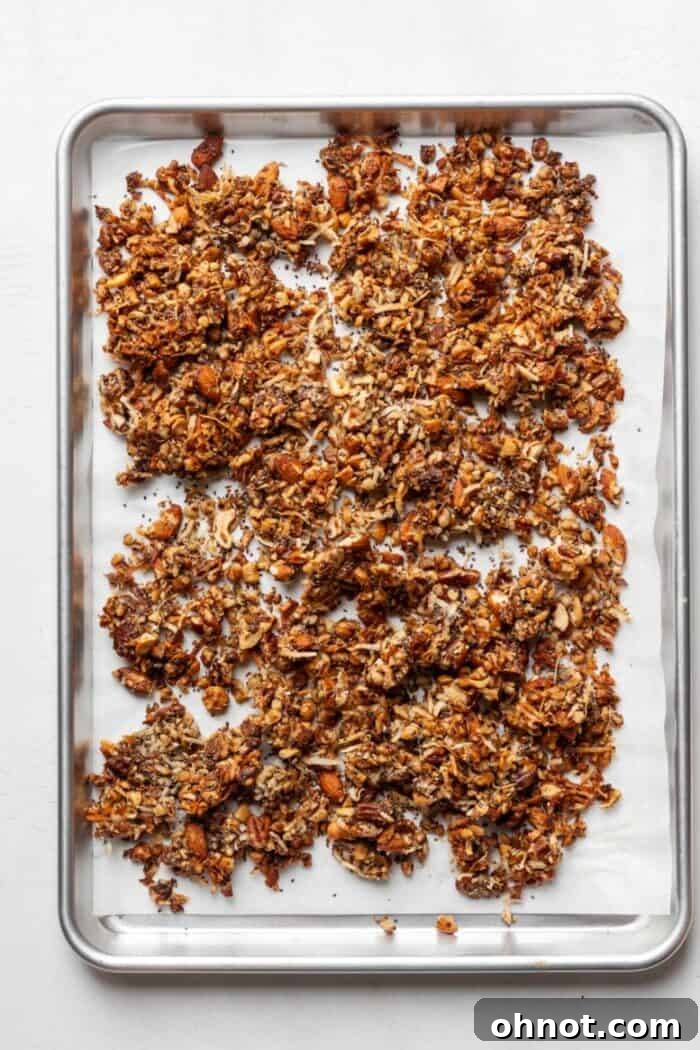 Whole30 granola cooling on a pan, forming crispy chunks for a perfect snack