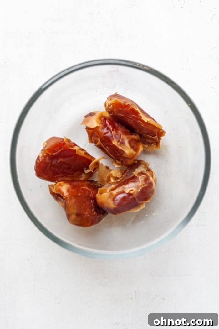 Pitted dates soaking in warm water, a key step for creating natural sweetness in Whole30 granola