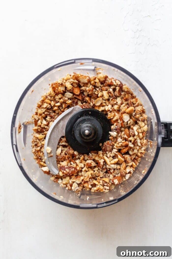 Chopped nuts in food processor, mixed with date paste for Whole30 compliant granola