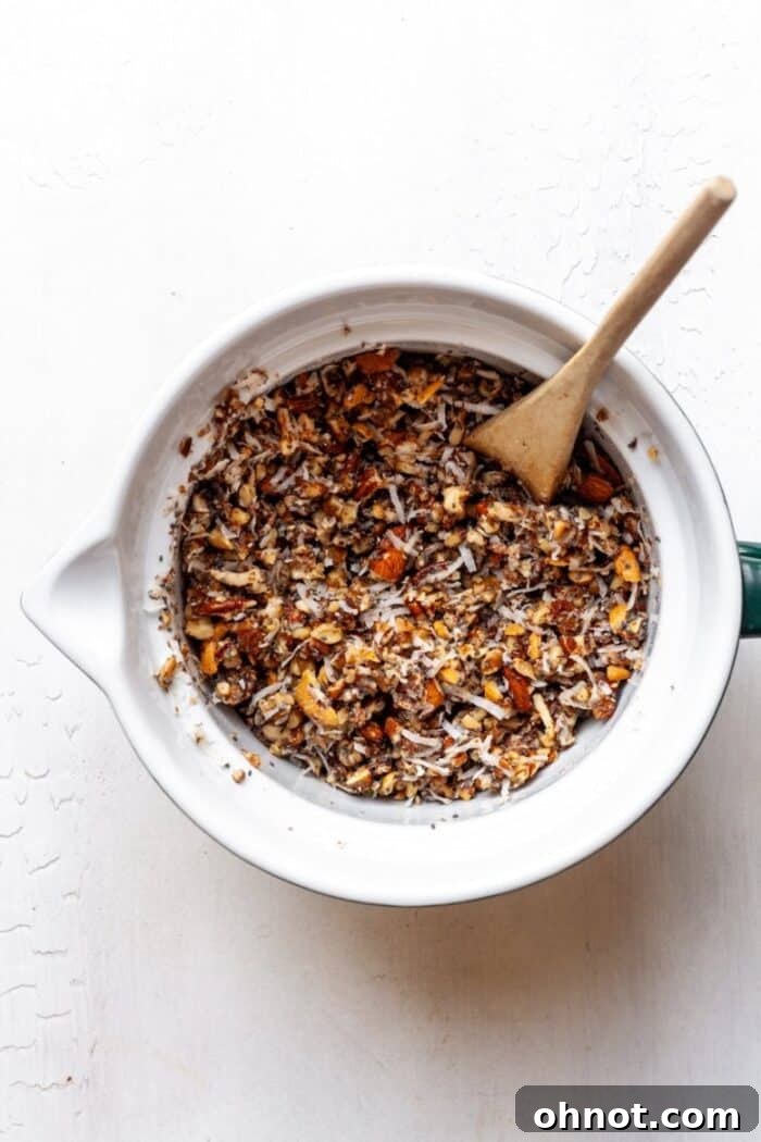 Granola mixture in a bowl, showing the combined ingredients before baking