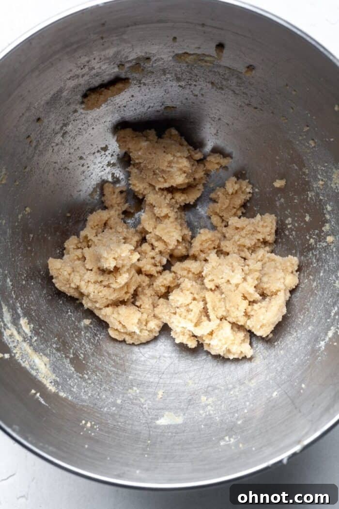 Creamed butter and sugar mixture in a stand mixer bowl, showing fluffy texture