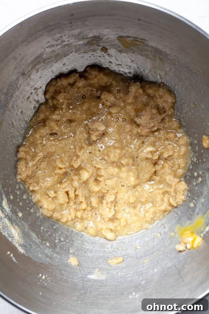 Mixture of creamed butter, sugar, and eggs with vanilla extract in a mixing bowl