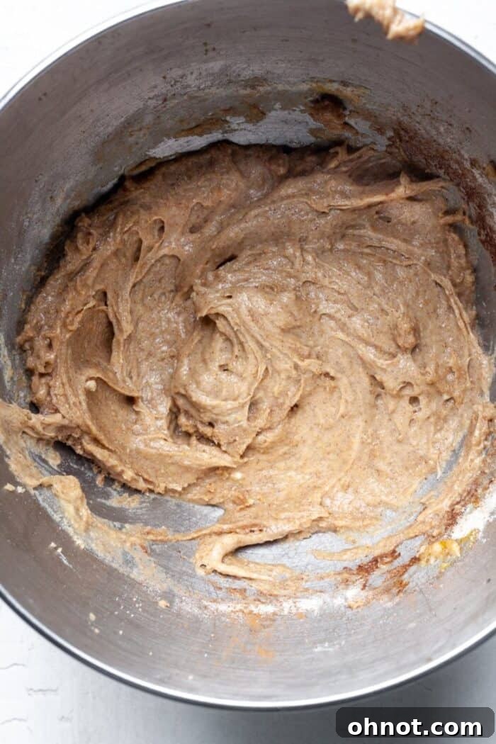 Finished gluten-free apple cider donut batter in a mixing bowl, thick and ready