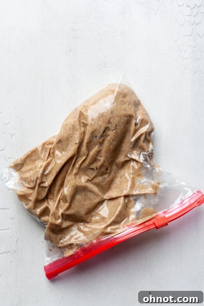 Donut batter neatly stored in a Ziplock bag with the corner snipped for piping