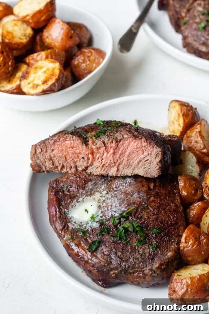 Medium-cooked ribeye steak on a plate, sliced and ready to eat, showing a perfect pink center