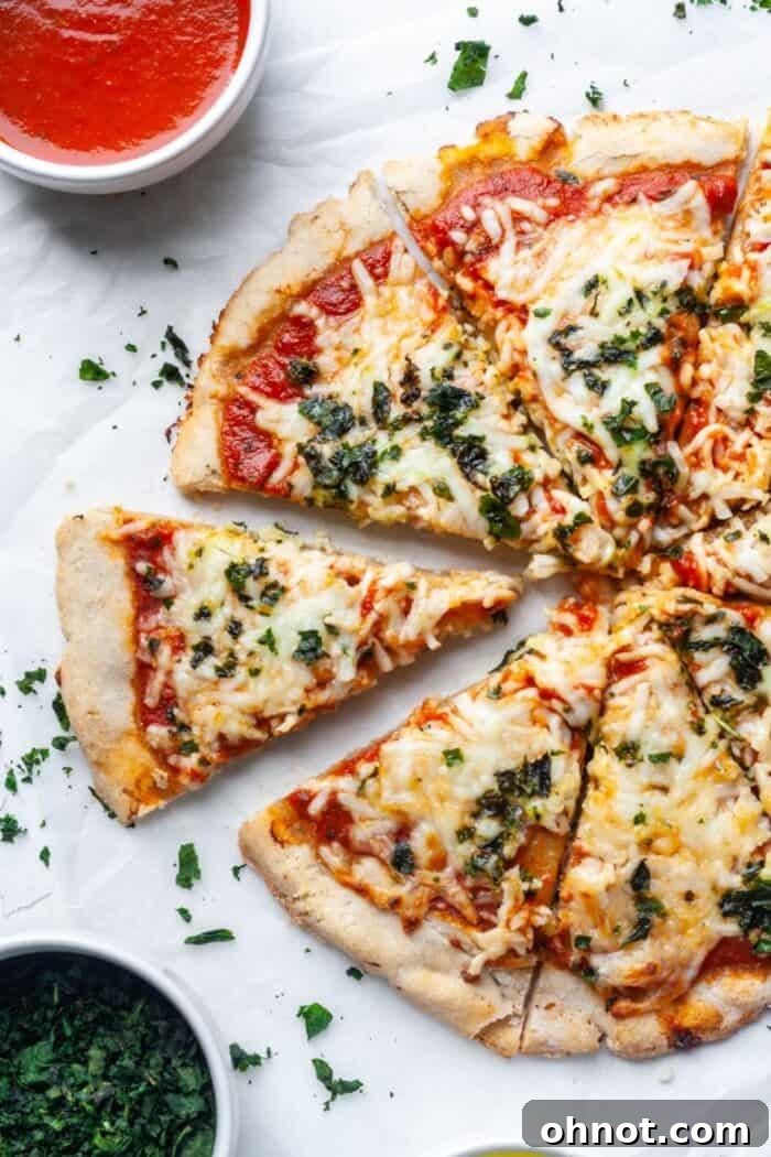 A vibrant Paleo pizza with assorted toppings, showcasing the sturdy and delicious grain-free crust.
