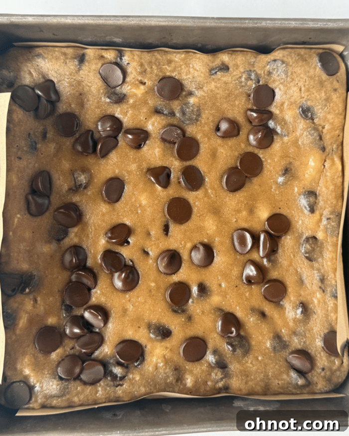 Freshly baked golden yellow banana blondies in a square pan, just out of the oven.