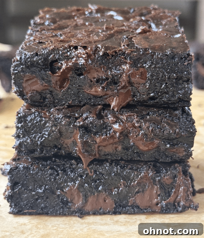 Close up of espresso brownies. A close-up, angled shot of the fudgy, glistening espresso brownies, highlighting their rich color and inviting texture, ready for a bite.