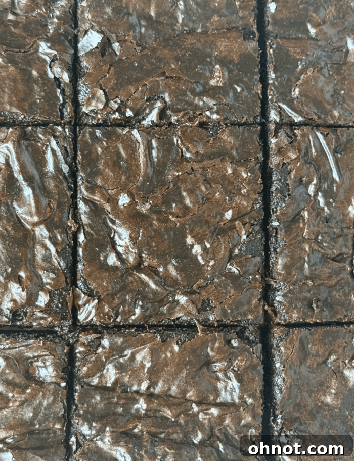 Cut chocolate squares. A neat arrangement of perfectly cut espresso brownie squares on a serving board, showcasing their glossy tops and dense texture, ready to be picked up.