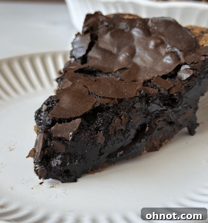 Decadent Brownie Pie with a crisp, shiny top, perfect for dessert.
