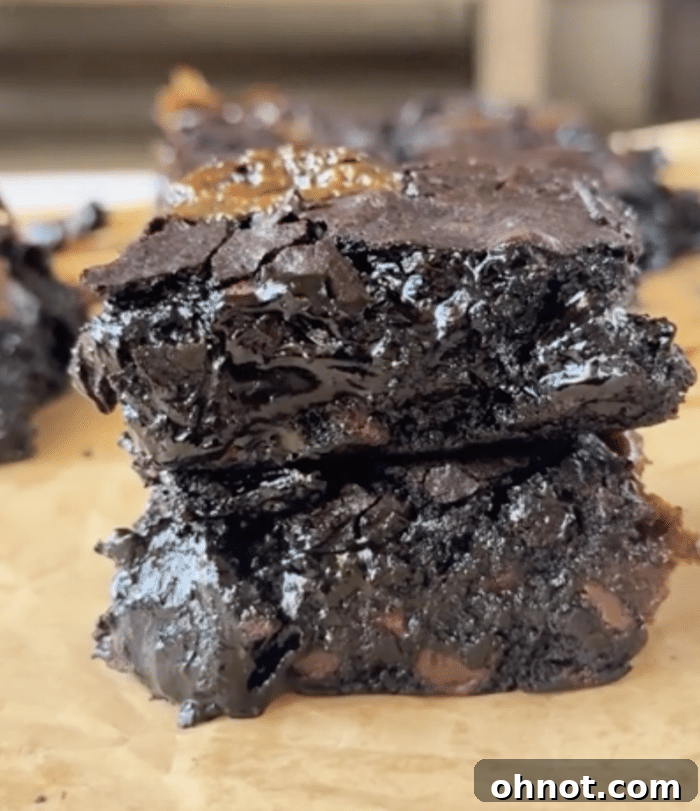 A close-up shot of a single caramel brownie square, showing the dense chocolate and rich caramel swirl.