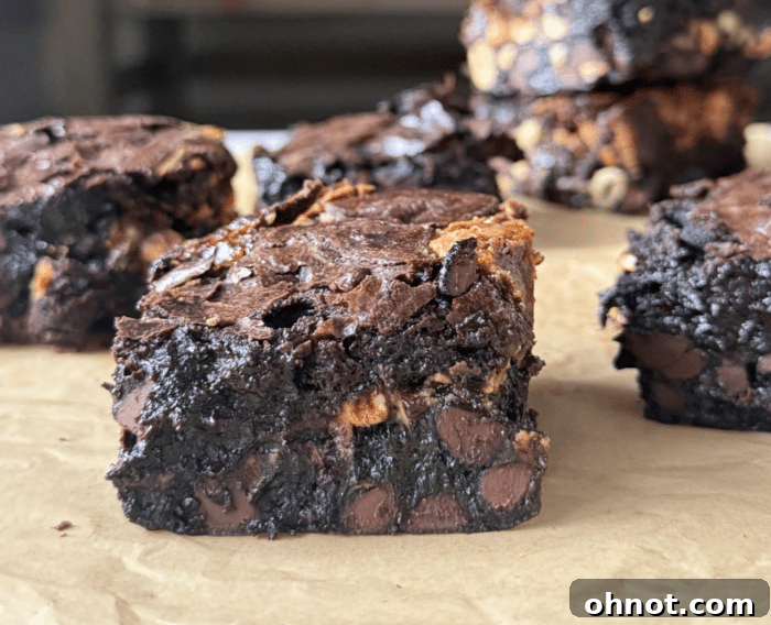 A close-up view of a Snickers brownie with visible peanut chunks.
